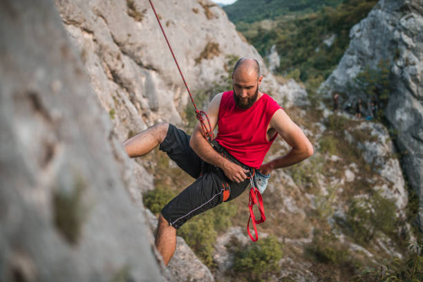 istock Focused male climber climbs a mountain during the day on extreme terrain 1724546794