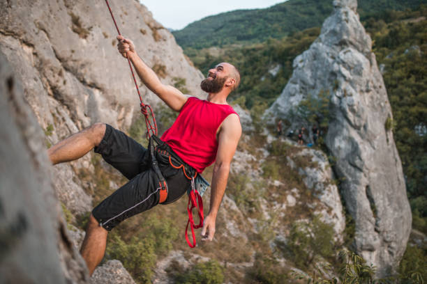 istock Male climber climbs a mountain during the day on extreme terrain 1724546952