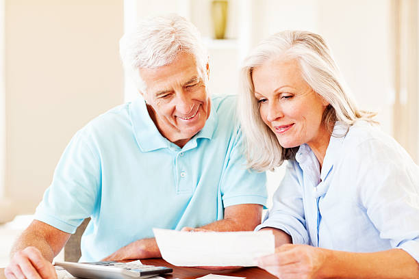 istock Happy Couple Calculating Monthly Expenses 172454736