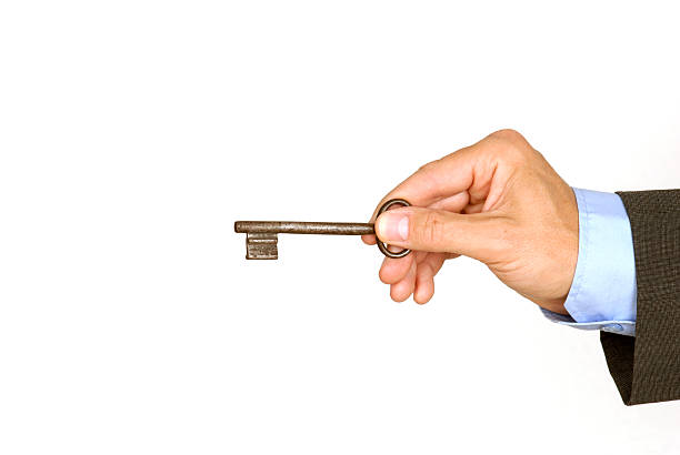 Male holding door key stock photo