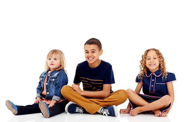 istock Young siblings sitting together on white background 172455403