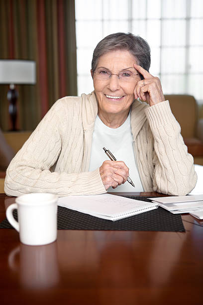 istock Senior Woman Paying Bills 172455977