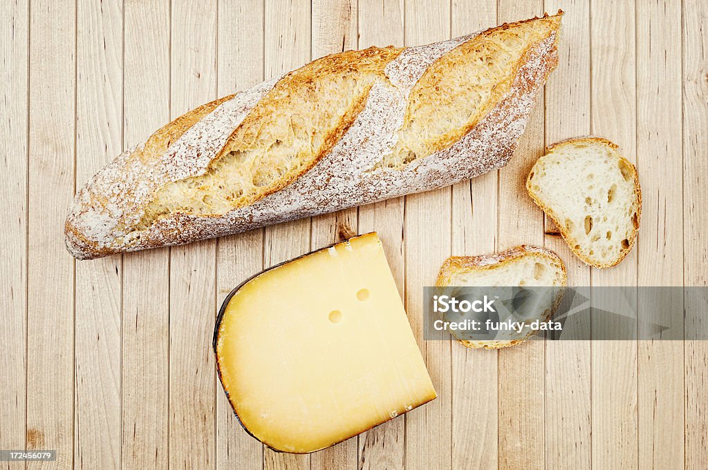 Bread and cheese Fresh bread and Dutch cheese from directly above on a wooden table top.See also Gouda Cheese Stock Photo