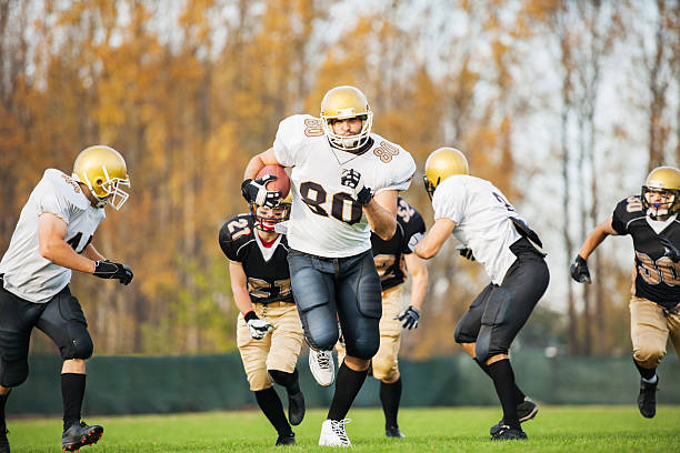 istock College Football - Catch and Tackle. 172456113