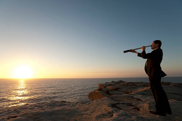 istock Businessman looking to the future with telescope 172456381