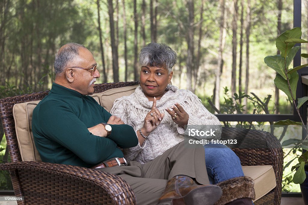 Relationships: Senior couple on screened porch arguing Relationships: Senior couple on screened porch arguing. She tells him what she needs him to do. He does not want to hear it.   Couple - Relationship Stock Photo