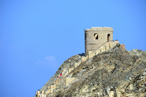 Riyam, Wilayat Muttrah, Muscat, Oman: Portuguese coastal defense tower at the harbor entrance, perched on a rocky promontory - used as protection against raids from Ottoman forces, now accessible via steep stairs on the cliff face - Al-Bahri road, the corniche.