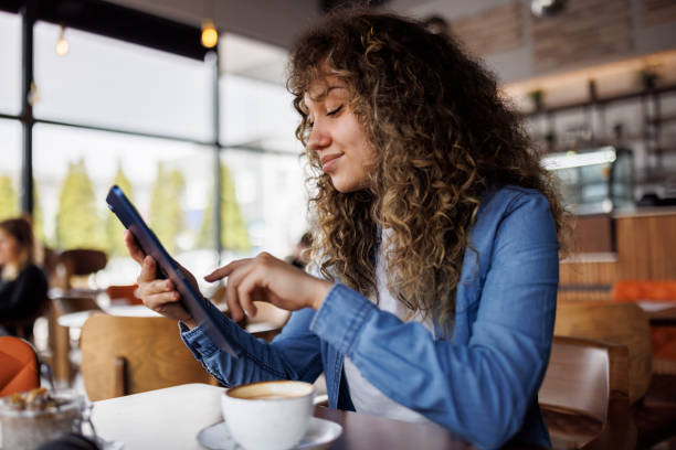 istock Young smiling woman enjoying coffee at a cafe 1724570063