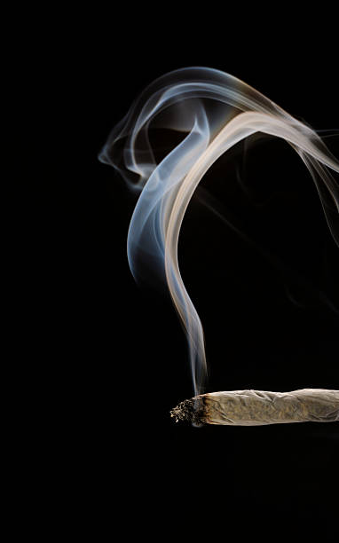 Smoking A Joint Stock Photo - Download Image Now - Marijuana Joint,  Cannabis Plant, Smoke - Physical Structure - iStock