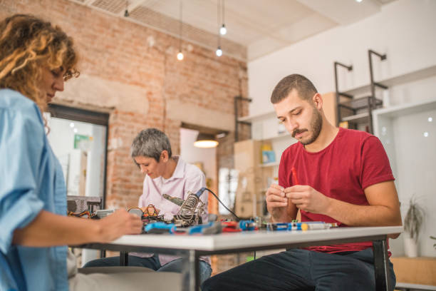 istock A small group of students and a teacher learn about hardware, motherboard, soldering in an electronics class 1724580280