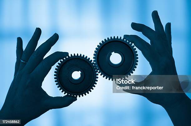 Hands Controlling Gear Working Togetherness Stock Photo - Download Image Now - Accuracy, Bicycle Gear, Blue