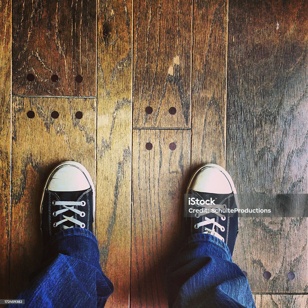 Standing Legs a person standing with legs and shoes on wood background. Shot with an iphone 5. Casual Clothing Stock Photo