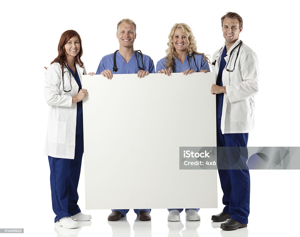 Equipe médica segurando uma placa do - Foto de stock de 20 Anos royalty-free