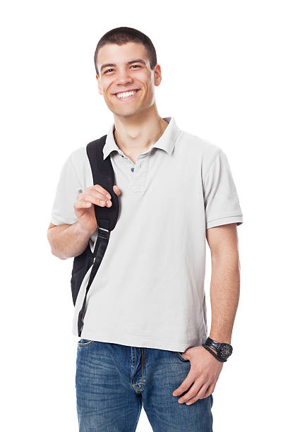 Caucasian male high school student poses with a backpack, smiling. Vertical shot. Isolated on white.