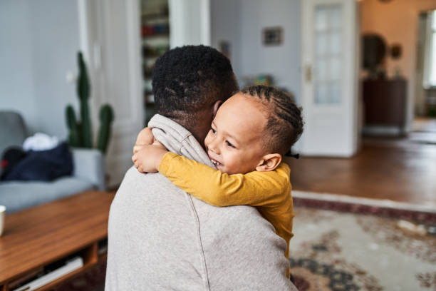 istock Happy little boy hugging his father while playing at home 1724604536