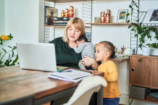 istock Single mother with her two kids working from home 1724613124