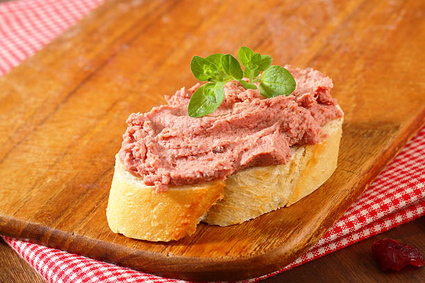 Slice of bread with liver pate Slice of bread with liver pate on  a cutting board animal liver stock pictures, royalty-free photos & images