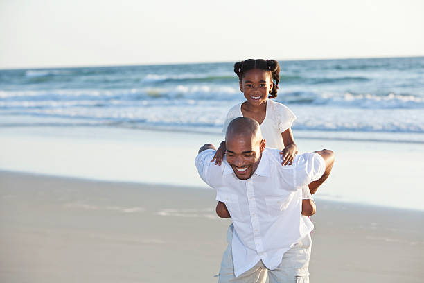 istock Father and daughter playing on beach 172462254