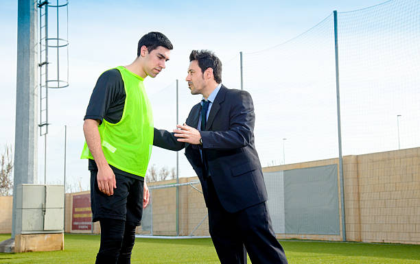 Coach a soccer plaer Soccer coach giving advice to a field player. Chest Protector stock pictures, royalty-free photos & images