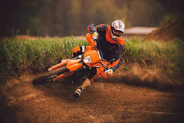 Motocross rider on track. Cross-processed and strong grain added to create atmosphere.