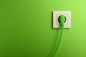 Electric socket in on green wall