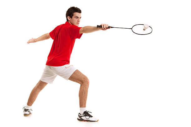 Badminton player with a racket in his hand hit shuttlecock Badminton player with a racket in his hand hit shuttlecock.Isolated on white background backhand stroke stock pictures, royalty-free photos & images