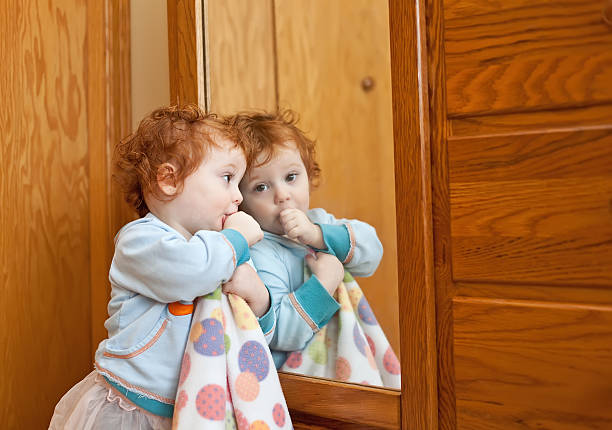 istock Little Girl Sucking Thumb by Mirror 172463867