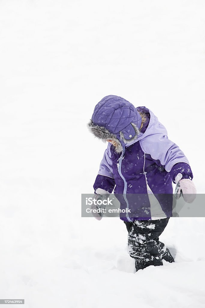 Girl Walking in Snow Girl walking in the snow during a snowstorm. 2-3 Years Stock Photo