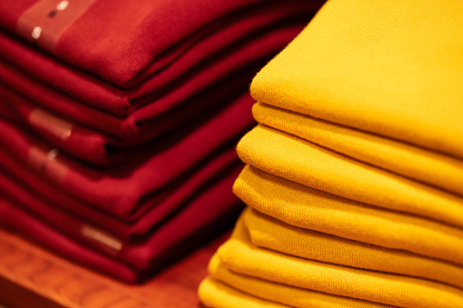 colourful pullovers on a desk in a shop