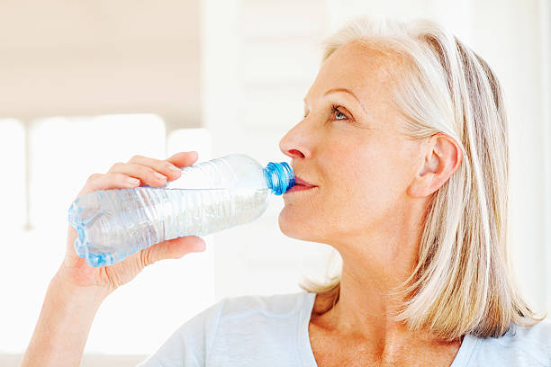 istock Senior woman drinking from a water bottle 172464100