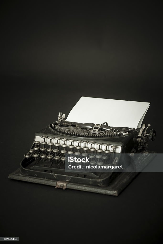 Antique typewriter 1930s typewriter with blank paper for your own copy. Author Stock Photo
