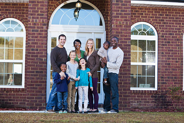 istock Two families in front of house 172464736