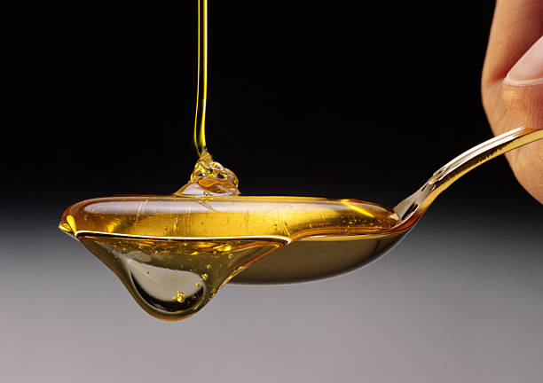 Honey Honey dripping off a spoon.More like this: teaspoon stock pictures, royalty-free photos & images