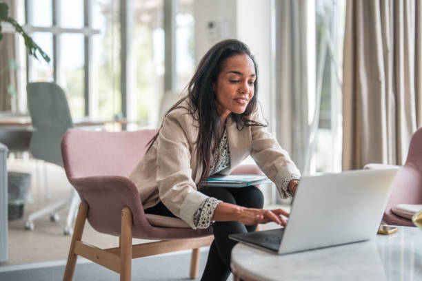 istock Successful Mid Adult Hispanic Employee at Her Desk 1724656949