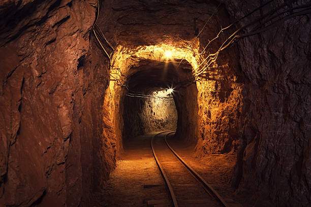 Mine Shaft "Mine shaft with railway deep underground in a lead and zinc mine (Mezica, Slovenia)." lead mine stock pictures, royalty-free photos & images