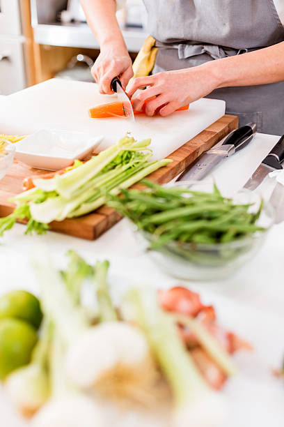 istock Woman Slicing carrots 172466316