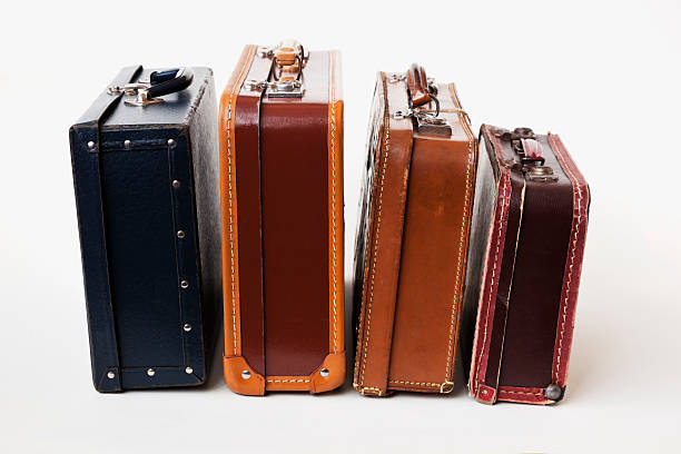 istock Vintage backlit   brown leather suitcases in a row. 172466445