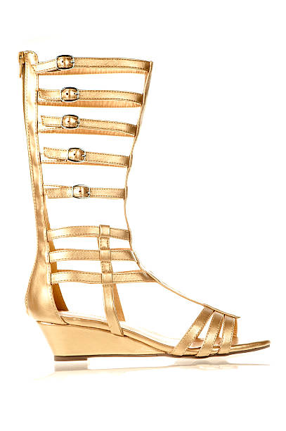 Fashionable shoes in gladiator sandals style. Fashionable Gladiator Sandals in gold color gladiator shoe stock pictures, royalty-free photos & images