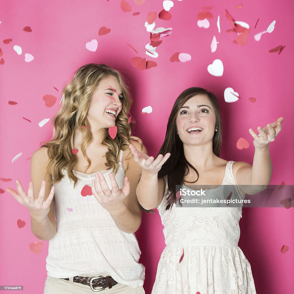 Valentine's Day Throwing Hearts A young couple throwing foam hearts into the air. Valentine's Day - Holiday Stock Photo