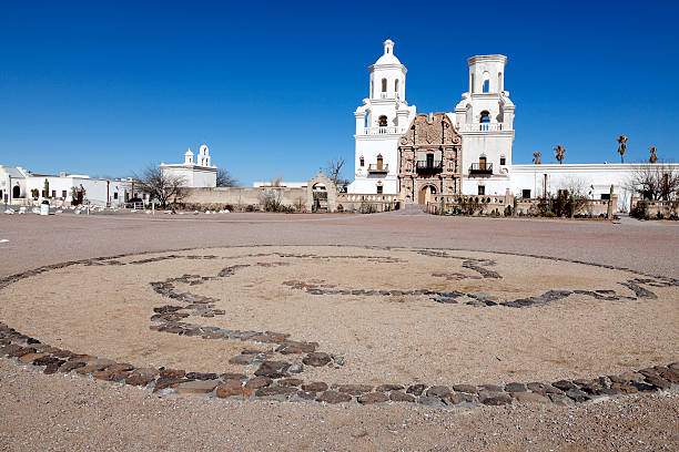San Xavier del Bac Mission The San Xavier del Bac Mission on the Tohono O'odham Indian Reservation near Tucson, Arizona, USA. tohono o'odham stock pictures, royalty-free photos & images