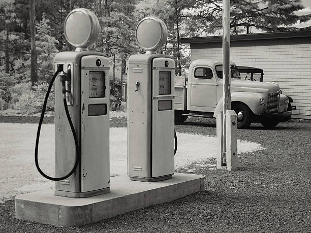 Antique Gas Station "Vintage fuel pumps and pickup trucks.  Shot in Infrared, light grain." gas station photos stock pictures, royalty-free photos & images
