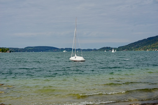 Sailboat on lake constance upwind on green water