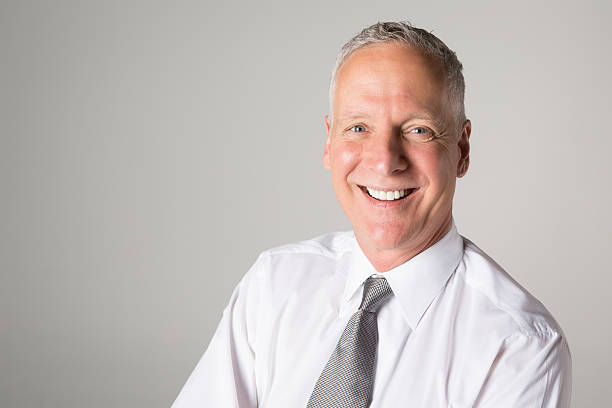 istock Happy mature man on a gray background with copy space 172468009