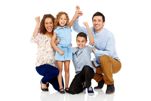 Portrait of excited parents and two children cheering together on white background
