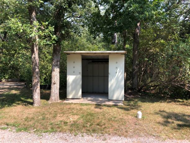 istock Metal shed with open doors near wooded are 1724681249
