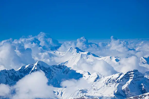 view over misty mountains from mount titlis, engelberg, switzerland. 3200m above sea level.