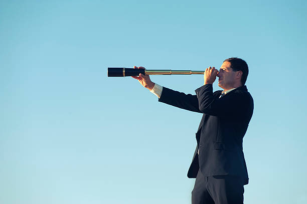 istock Businessman looking to the future with telescope 172469038