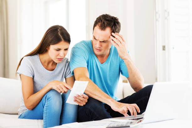 istock Couple With Laptop Examining Bills 172469260