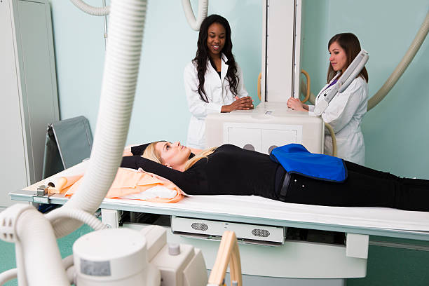 istock Young woman having x-ray exam...black radiologist 172470588