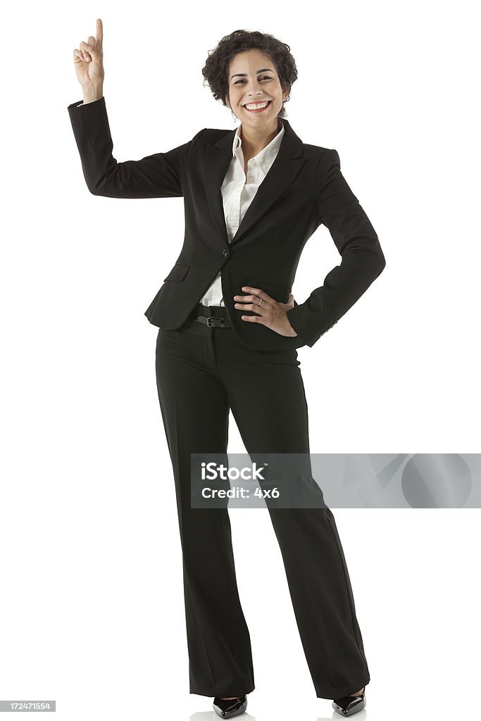 Sorridente donna d'affari rivolta verso l'alto - Foto stock royalty-free di Completo